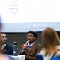 close up of a student panelist wearing a suit speaking